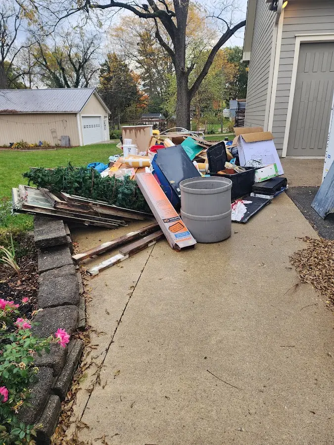 Dumpster being loaded with debris for Roofing Dumpster Rental in Parma